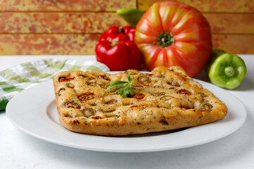 Traditional Italian focaccia with tomato and olives