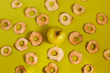 Pattern natural apple chips on a yellow background. Healthy vegan vegetarian fruit snacks. Organic products for wellness