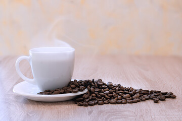 Close-up of a coffee Cup and scattered coffee beans.