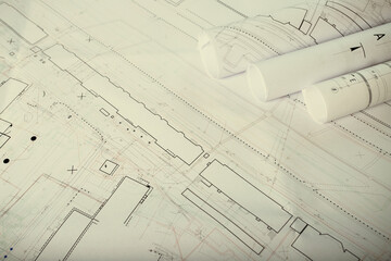 background of architectural blueprints and rolls with drawings