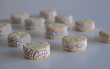 cornstarch alfajores filled with dulce de leche and sprinkled with grated coconut