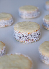 cornstarch alfajores filled with dulce de leche and sprinkled with grated coconut