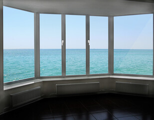 Fototapeta na wymiar Cozy room overlooking sea. Landscape with ocean. Window with beautiful panorama