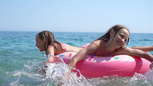 Little girls having fun at tropical beach during summer vacation playing together