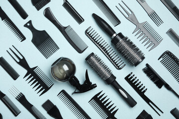 Flat lay composition with modern hair combs and brushes on light background