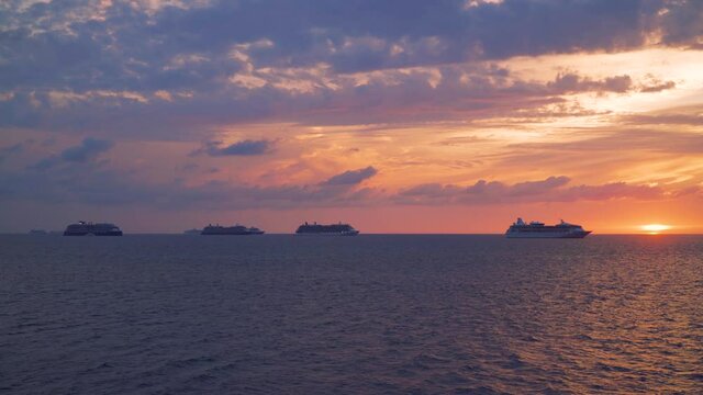 Cruise ships anchored at sea - sunset sky and horizon line