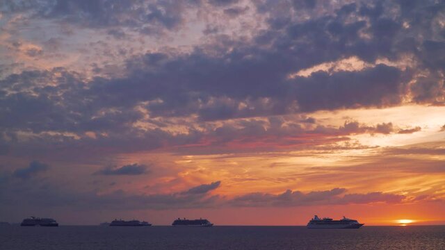 Six cruise ships on anchor in the middle of the ocean - sunset time