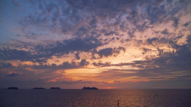 Six cruise ships on anchor in the middle of the ocean - sunset time