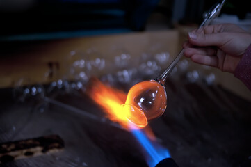 Heating a glass tube to form a special Christmas bauble.