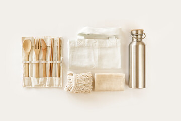 Fototapeta na wymiar Eco friendly accessories - bamboo cutlery, eco bag, reusable water bottle. Zero waste, plastic free concept, sustainable lifestyle. Top view, flat lay.