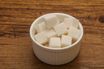 Refined white sugar cubs in the bowl