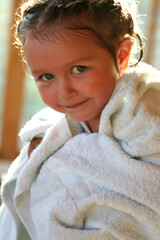 portrait of a little girl wrapped in a towel