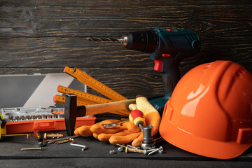 Different construction accessories on dark wooden table