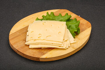 Sliced yellow cheese over board
