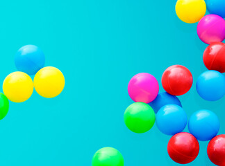 Fototapeta na wymiar Multi colored balls levitation in mid air on blue background.
