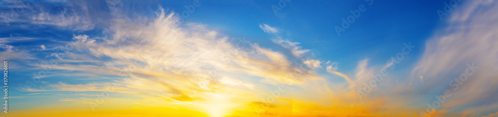 Wall mural panorama of the evening dramatic sky with bright sun