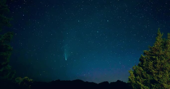 Time lapse of comet Neowise moving across a starry sky during aurora borealis