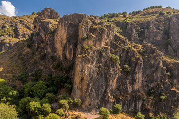 A view past the gorge of Monachil river in the Sierra Nevada mountains, Spain in the summertime