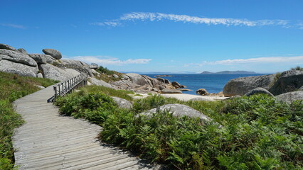 Fototapeta na wymiar Wooden footpath along the coast in Galicia, Spain, Atlantic ocean, province of Pontevedra, Praia Abelleira, San Vicente do Grove