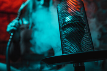 Girl smokes a hookah in blue neon lighting