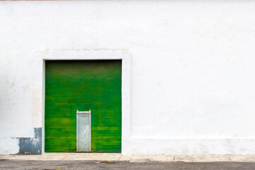 Naklejka na ściany i meble White wall background with metallic green curtain. copy space.