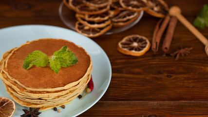 Homemade pancakes with spices, cinnamon and dried orange