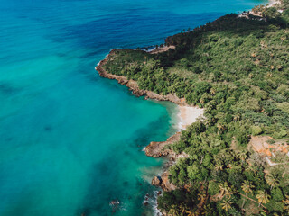 Fototapeta na wymiar Aerial drone view of rocky shore of the Atlantic ocean with blue water lagoon in Las Galeras, Samana, Dominican Republic 