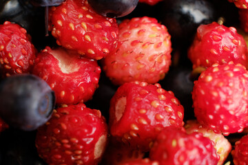 Macro shot of fresh blueberries and strawberries salad.