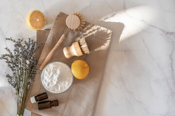 Zero waste kitchen cleaning concept. Eco friendly natural cleaning tools and products, bamboo dish brushes and lemon with baking soda. No plastic, eco-friendly lifestyle. Top view, flat lay.