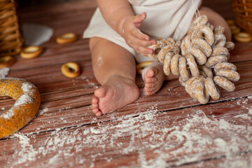 
child holds bagel gingerbread in hand
