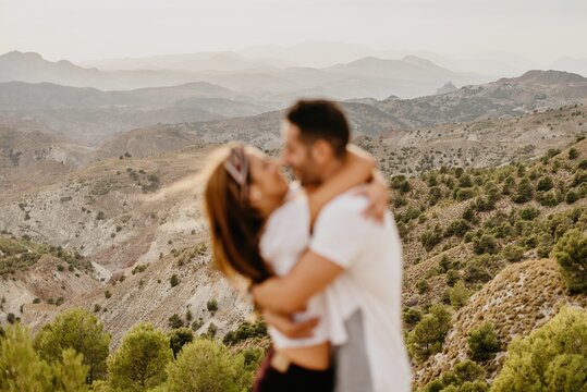 Young couple in love enjoying in mountains