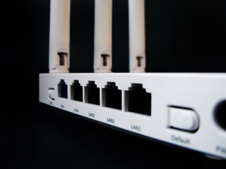 A white router for connecting to the Internet on a dark background.