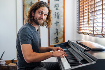 Talented man playing piano at home