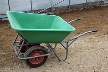 Two-wheeled wheelbarrow ( hand cart ) in a green house