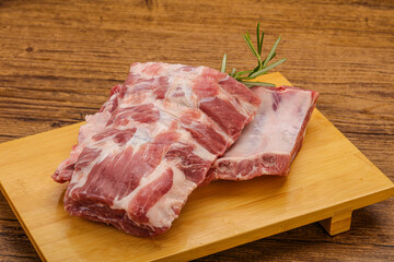 Raw pork ribs served rosemary