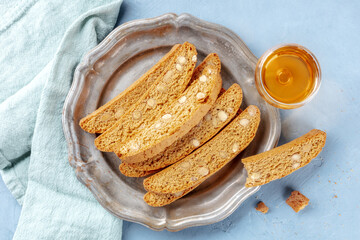 Biscotti, traditional Italian almond biscuits, with a glass of vin santo sweet wine, shot from the top