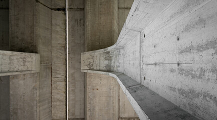 From below of vertical narrow concrete rubbish chute with spots on grey surface and solid texture near metal partition