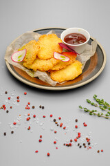 Grilled chicken fillet. Chicken nuggets with sauce on a white plate.
