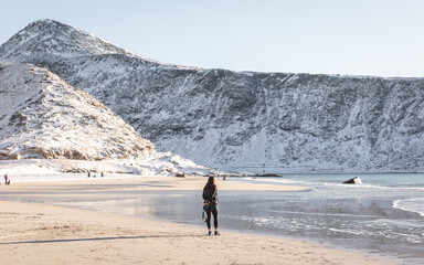 A hiker explores a beautiful beach in Norway. 