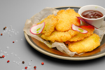 Grilled chicken fillet. Chicken nuggets with sauce on a white plate.