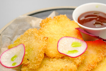 Grilled chicken fillet. Chicken nuggets with sauce on a white plate.