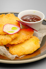 Grilled chicken fillet. Chicken nuggets with sauce on a white plate.