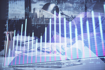 Double exposure of stock market graph drawing and office interior background. Concept of financial analysis.