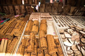 Traditional bamboo slips with hieroglyphs placed on counter on local bazaar with souvenirs