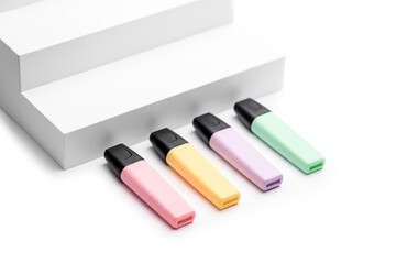 Pastel highlighters on white steps background