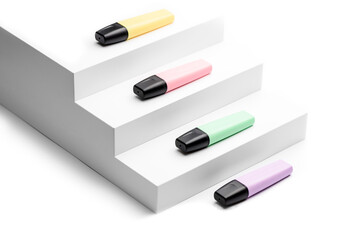 Pastel highlighters on white steps background