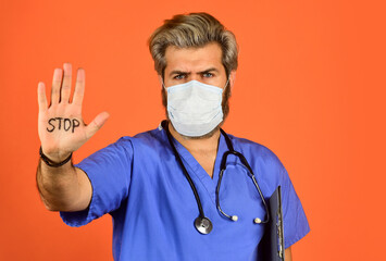 Epidemic threshold. Man in medical lab. Protective mask. Open palm stop gesture. Danger zone. Stop...