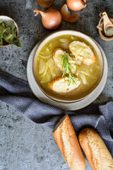 Classic French onion soup in a ceramic bowl, topped with baguette slices and shredded cheese