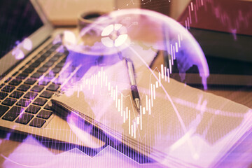 Double exposure of forex chart drawing and desktop with coffee and items on table background. Concept of financial market trading