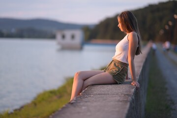 utdoor portrait of blond Caucasian teenage girl standing on a seacoast